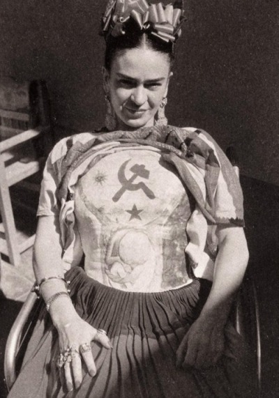 Frida Kahlo wearing a plaster cast, which she decorated with the hammer and sickle (c.1950) photo by Florence Arquin